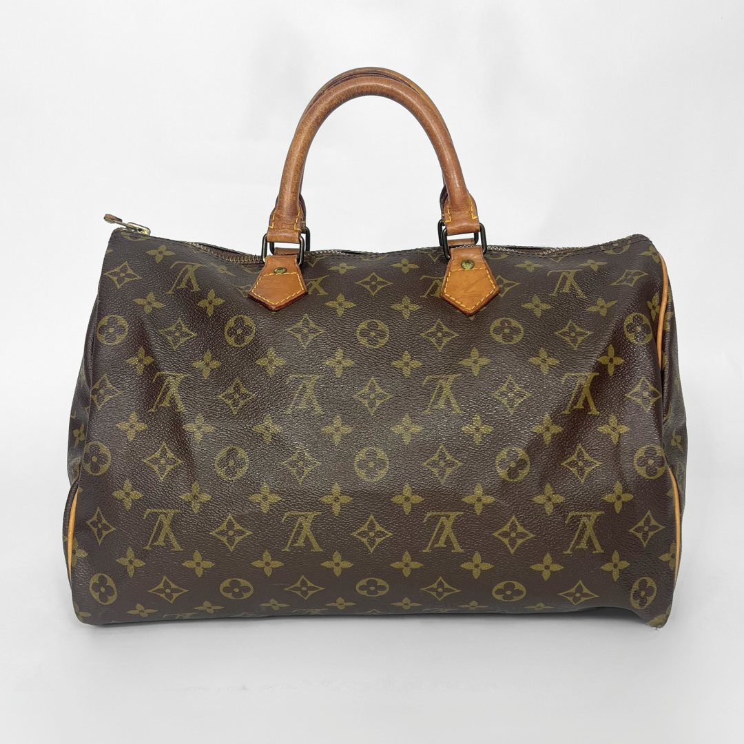 Brown handbag with monogram pattern on a white background