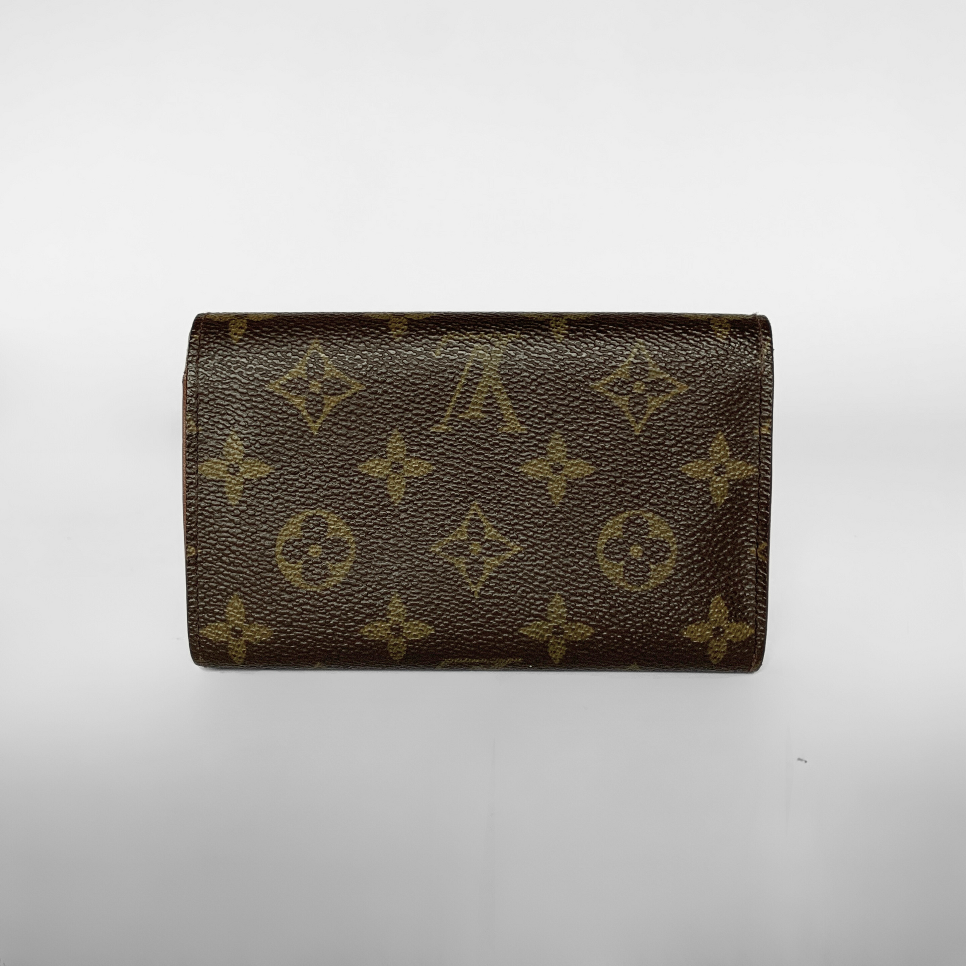 Louis Vuitton wallet with monogram pattern on a white background