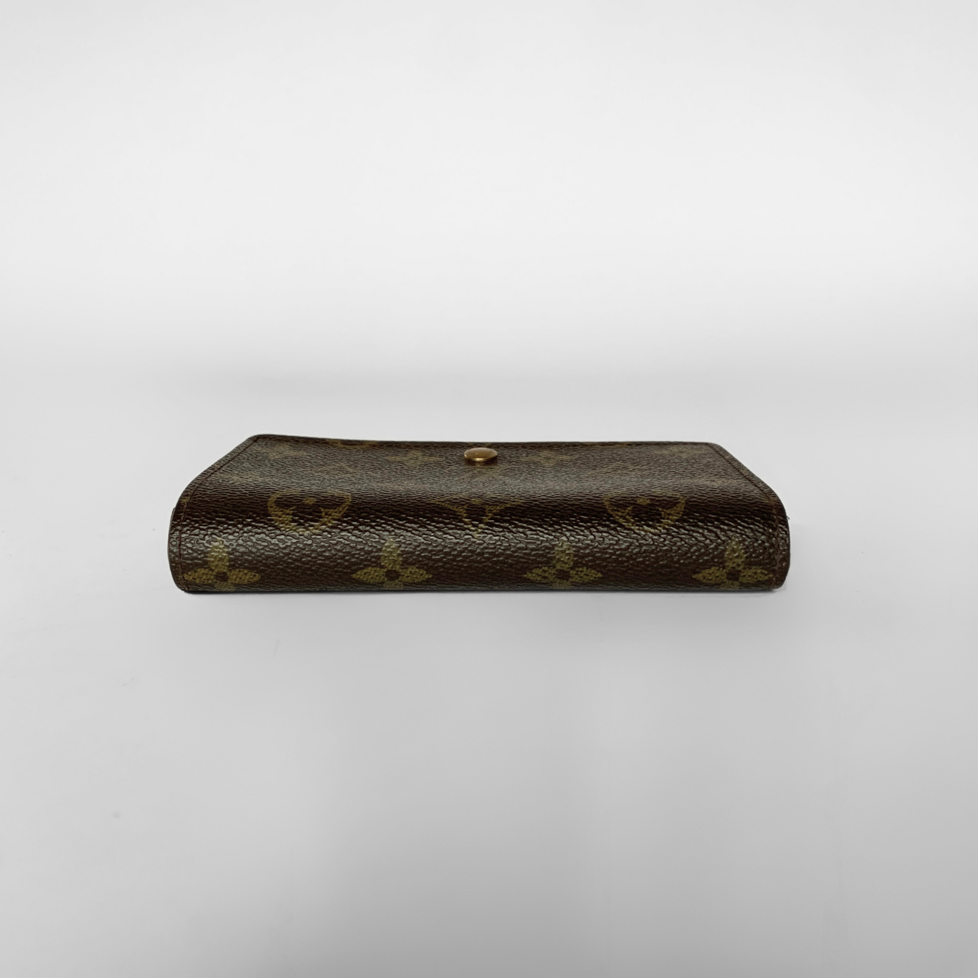 Louis Vuitton wallet with monogram pattern on a white background