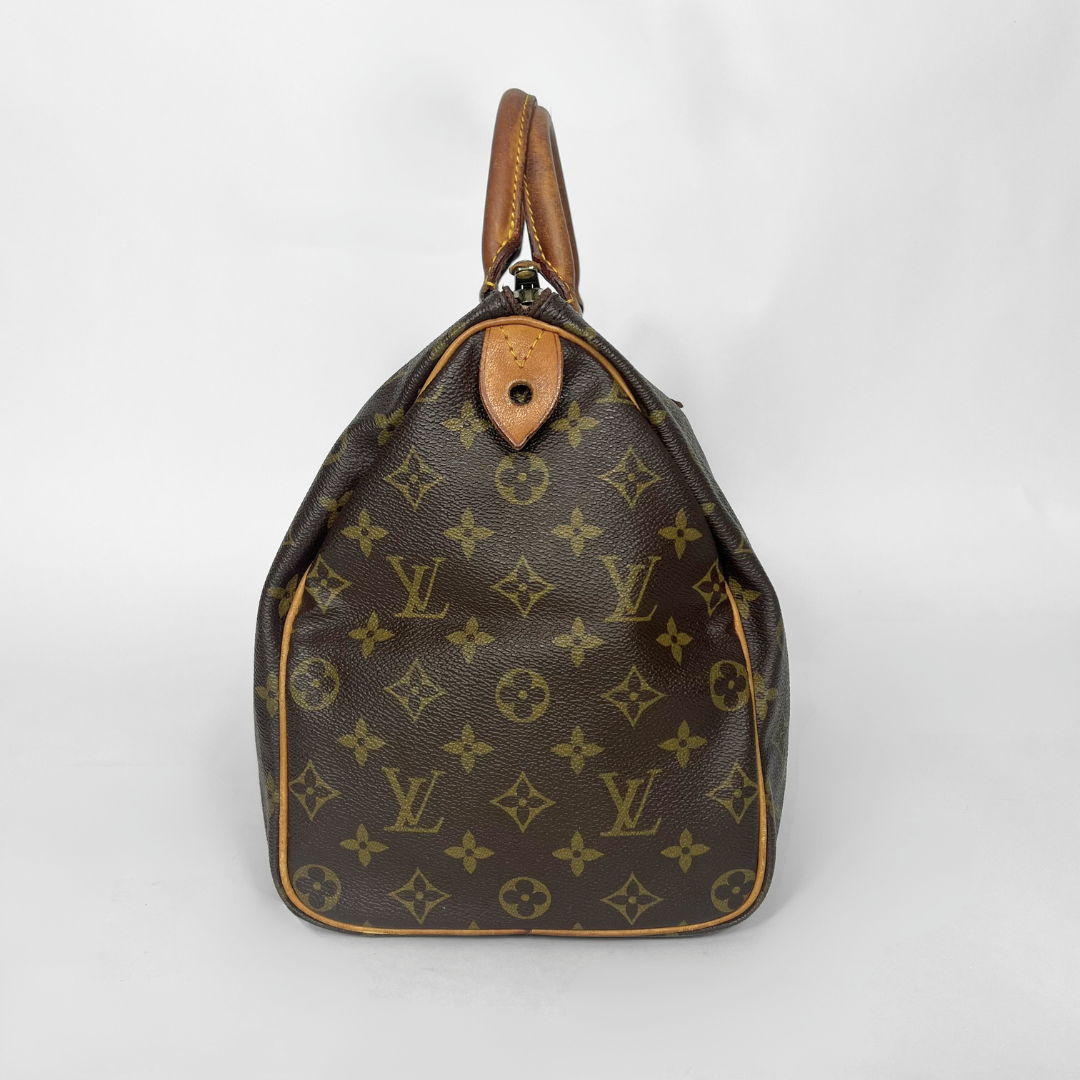 Brown Louis Vuitton handbag with monogram pattern on a white background
