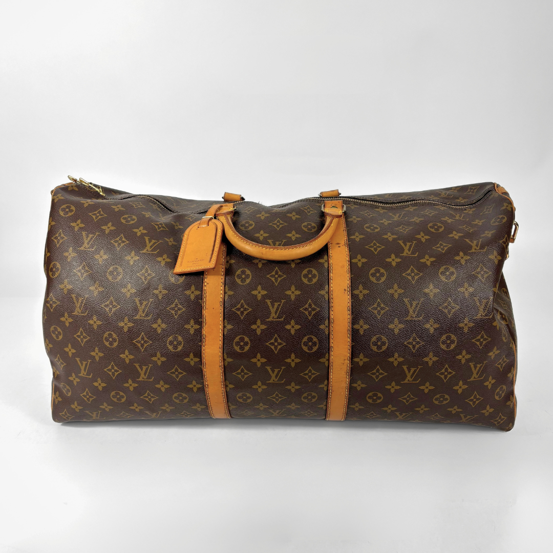 Brown Louis Vuitton travel bag with monogram pattern on a white background