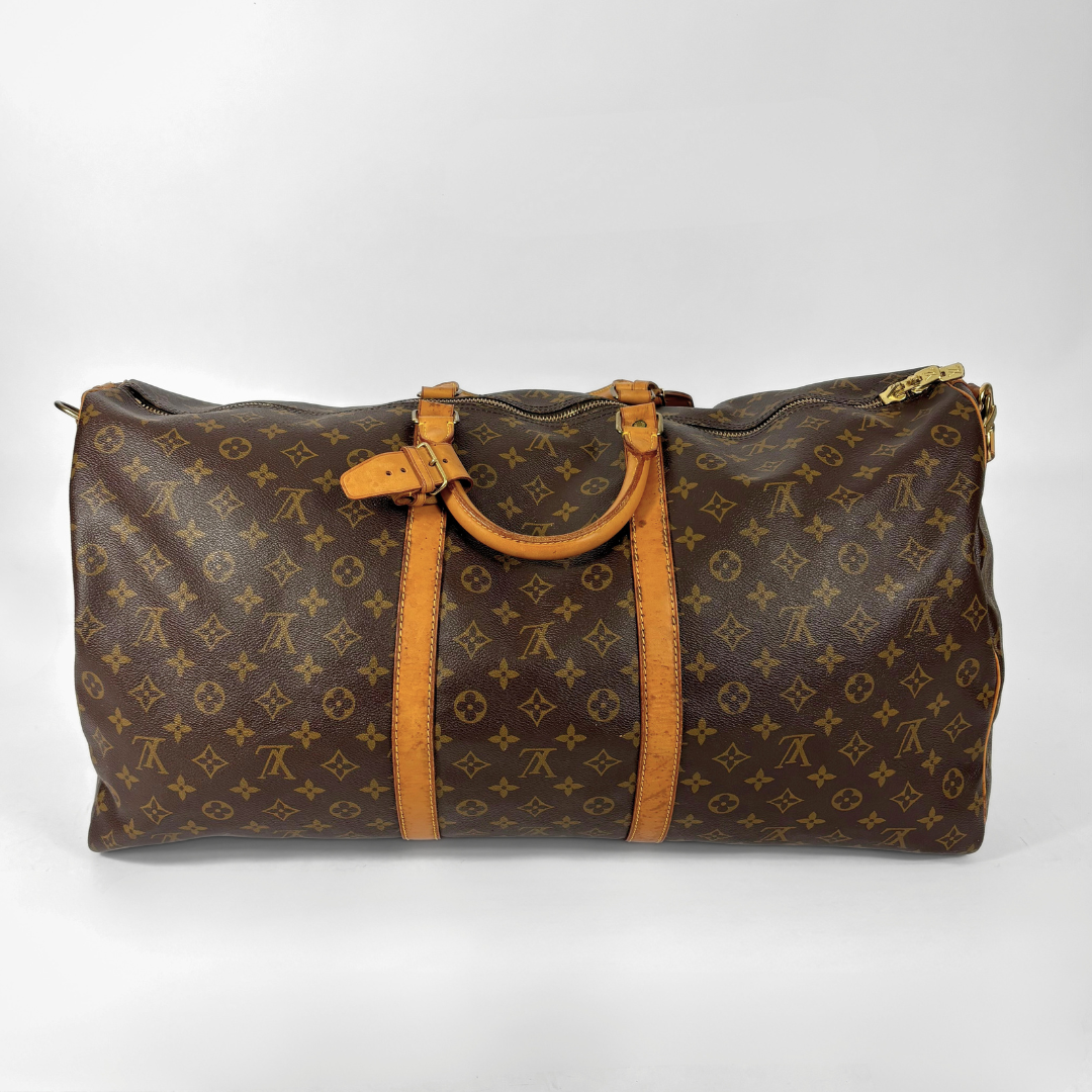 Brown Louis Vuitton travel bag with monogram pattern on a white background