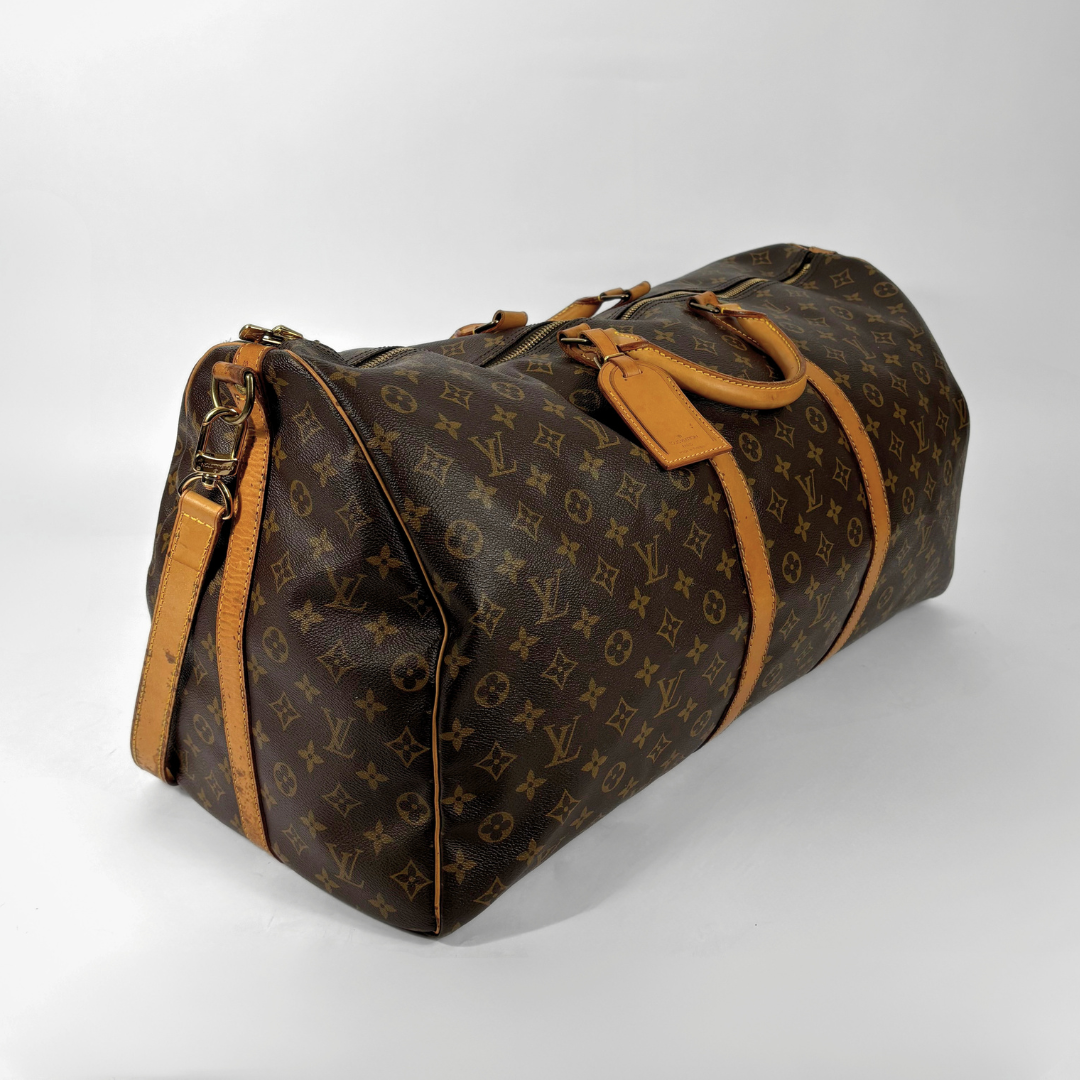 Brown Louis Vuitton travel bag with monogram pattern on a white background