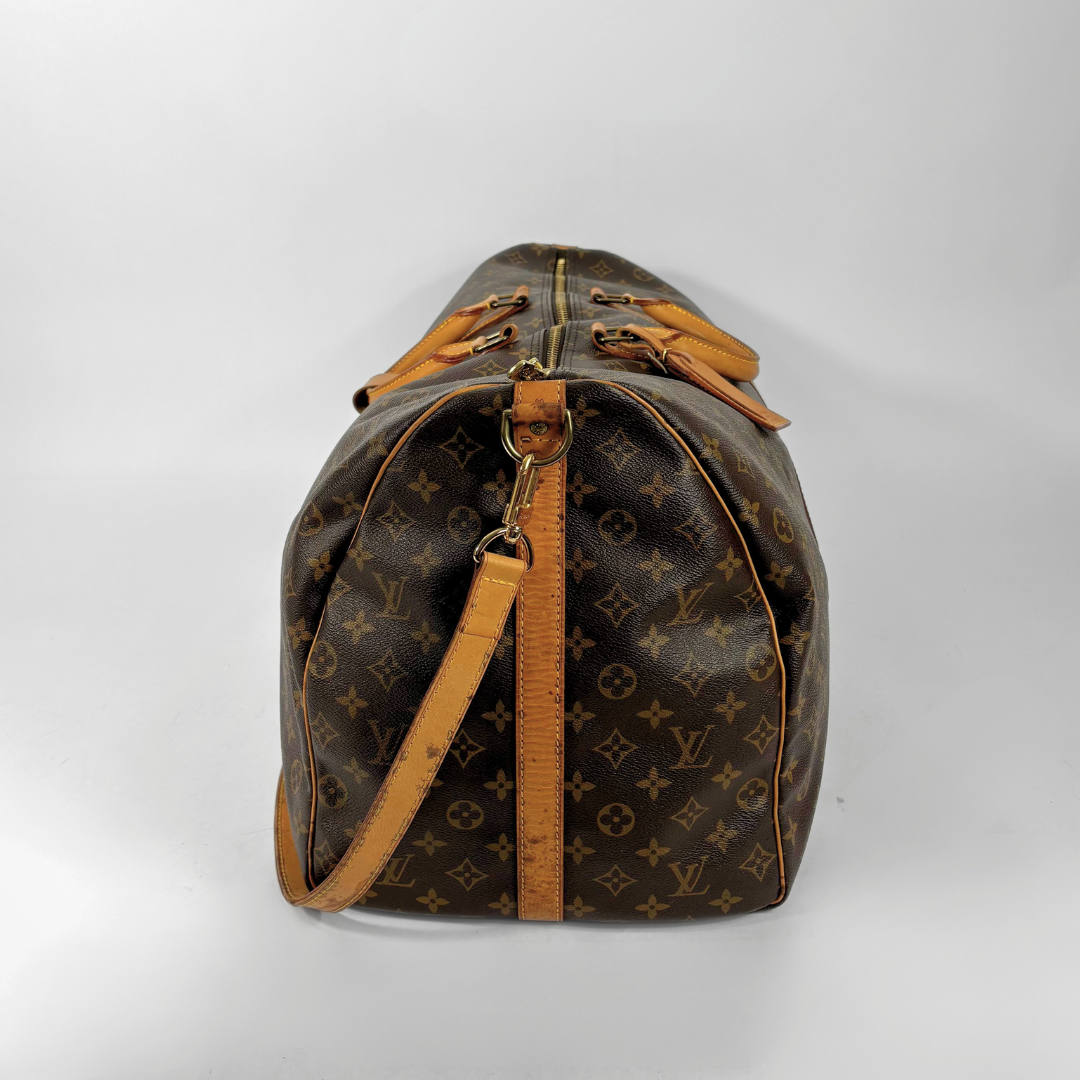 Brown Louis Vuitton travel bag with monogram pattern on a white background
