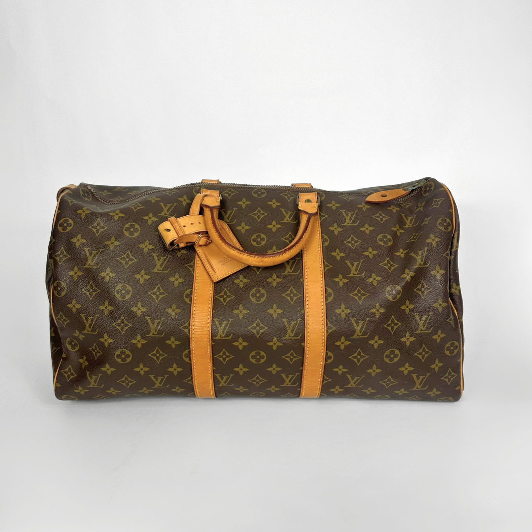 Designer handbag with monogram pattern on a white background