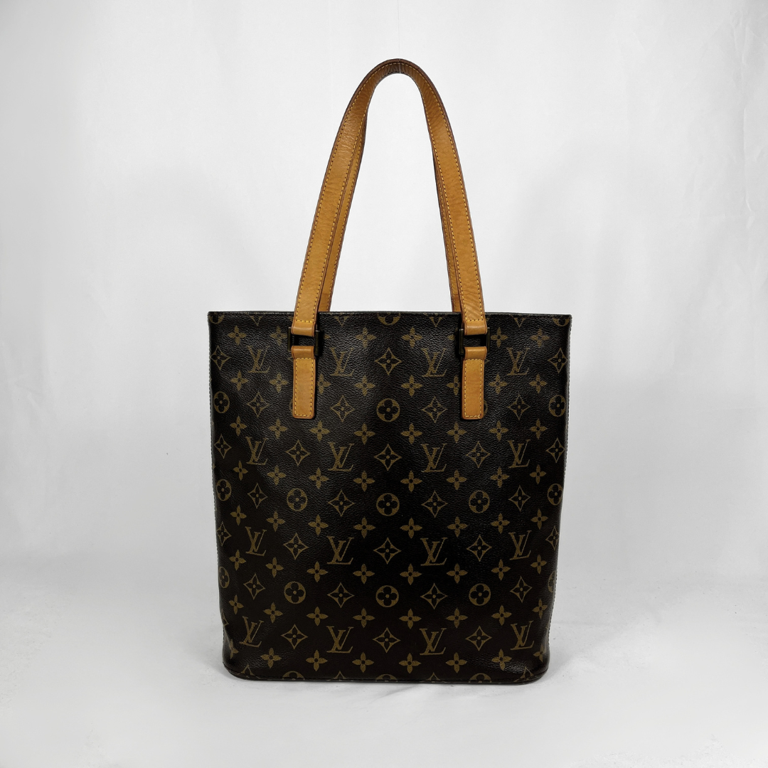 A Louis Vuitton monogram canvas tote bag with tan leather shoulder straps, photographed against a white studio background.