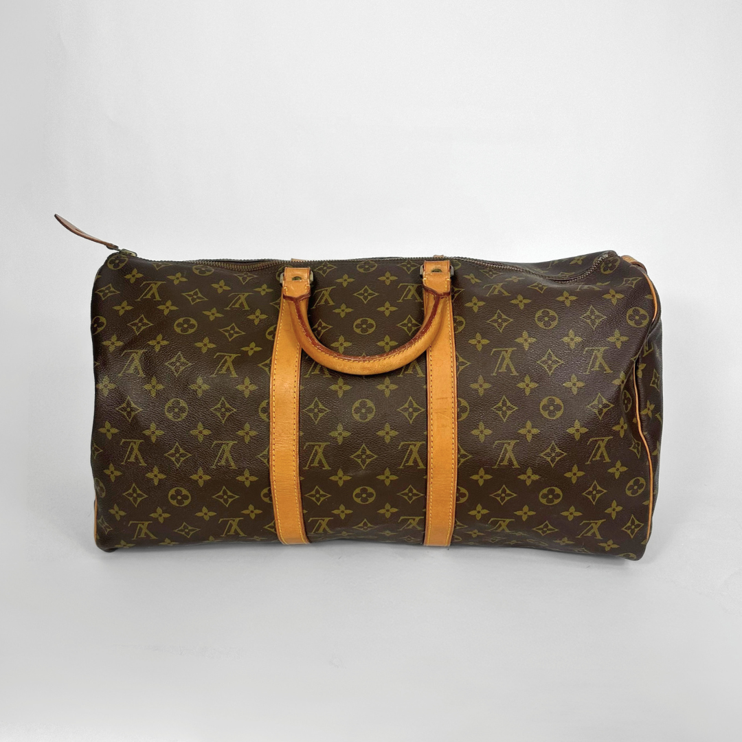 Designer handbag with monogram pattern on a white background