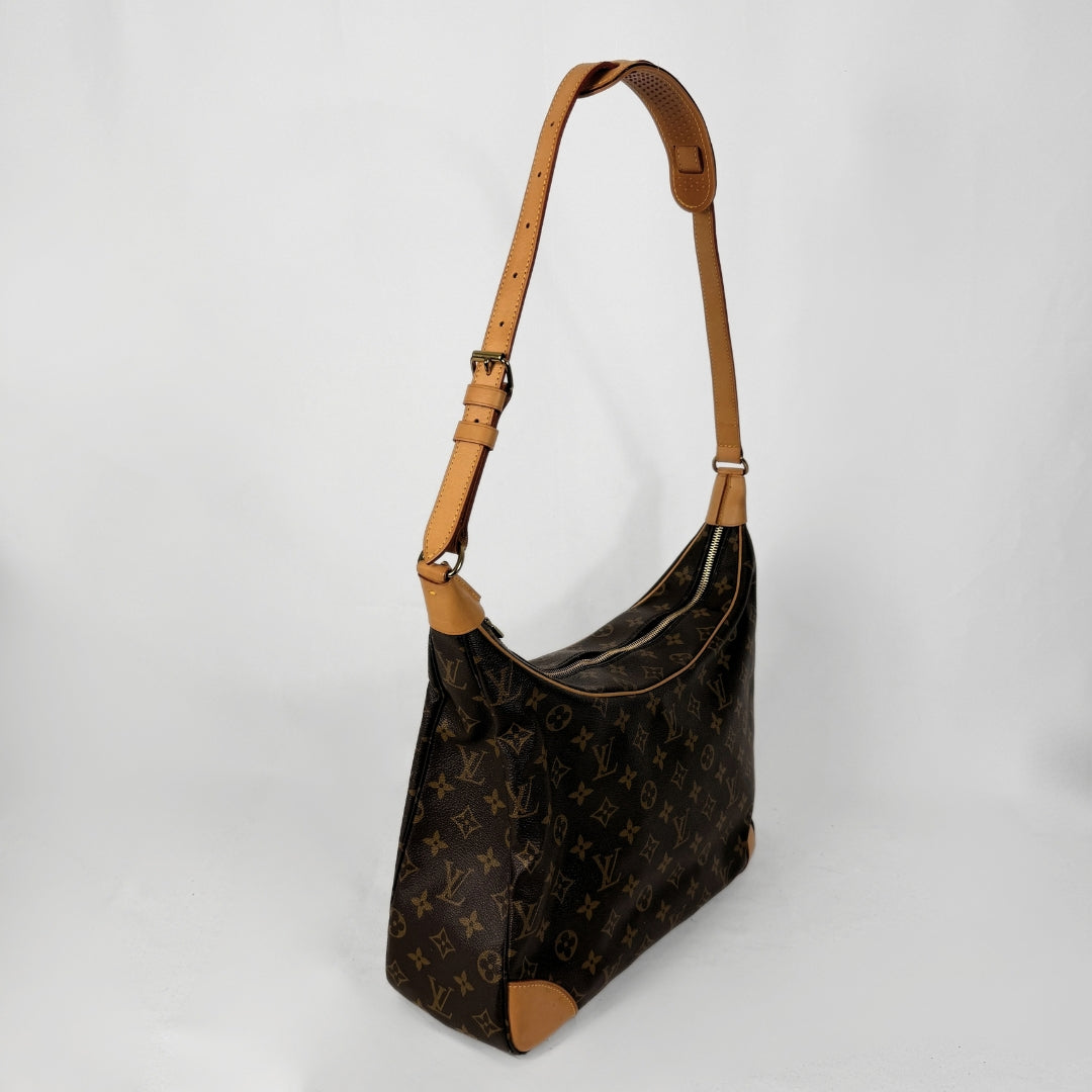 A Louis Vuitton monogram shoulder bag in brown coated canvas with tan leather trim and strap, photographed on a light gray studio background.