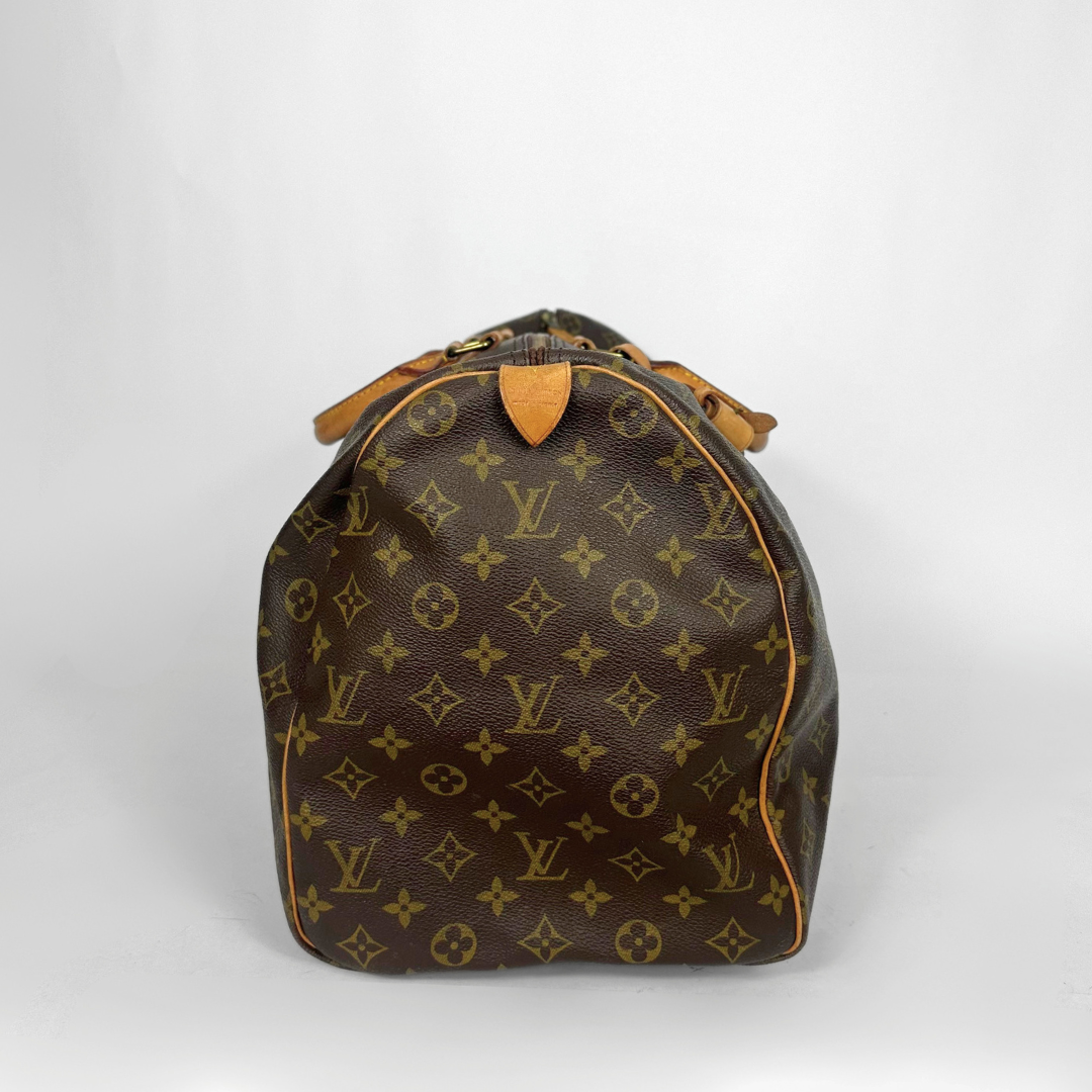 Designer handbag with monogram pattern on a white background