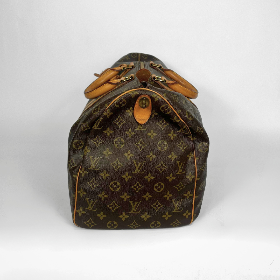 Designer handbag with monogram pattern on a white background