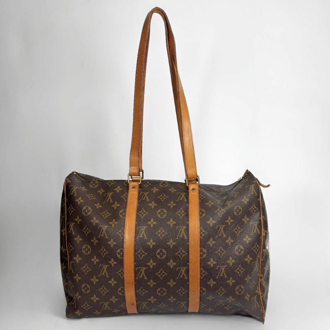 A Louis Vuitton monogram canvas duffel bag with tan leather shoulder straps and trim, photographed against a neutral light gray background.