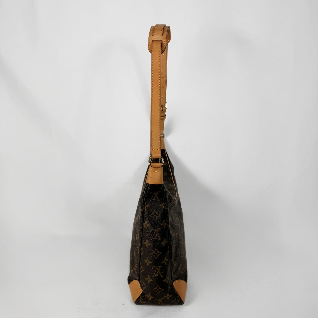 A Louis Vuitton monogram shoulder bag in dark brown coated canvas with tan leather trim and strap, shown from a side profile view against a light gray background.