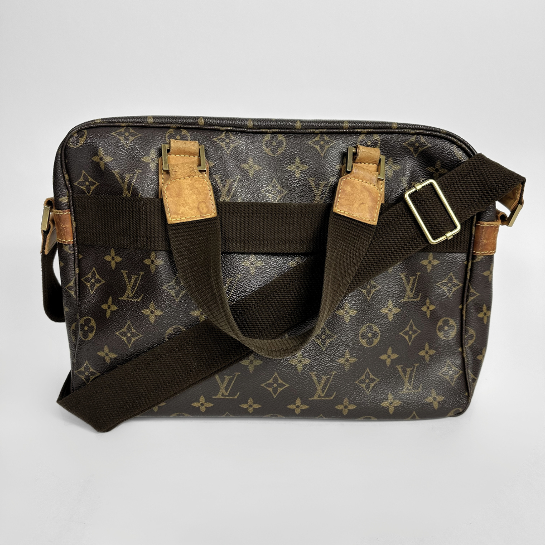 Designer handbag with monogram pattern on a light gray background
