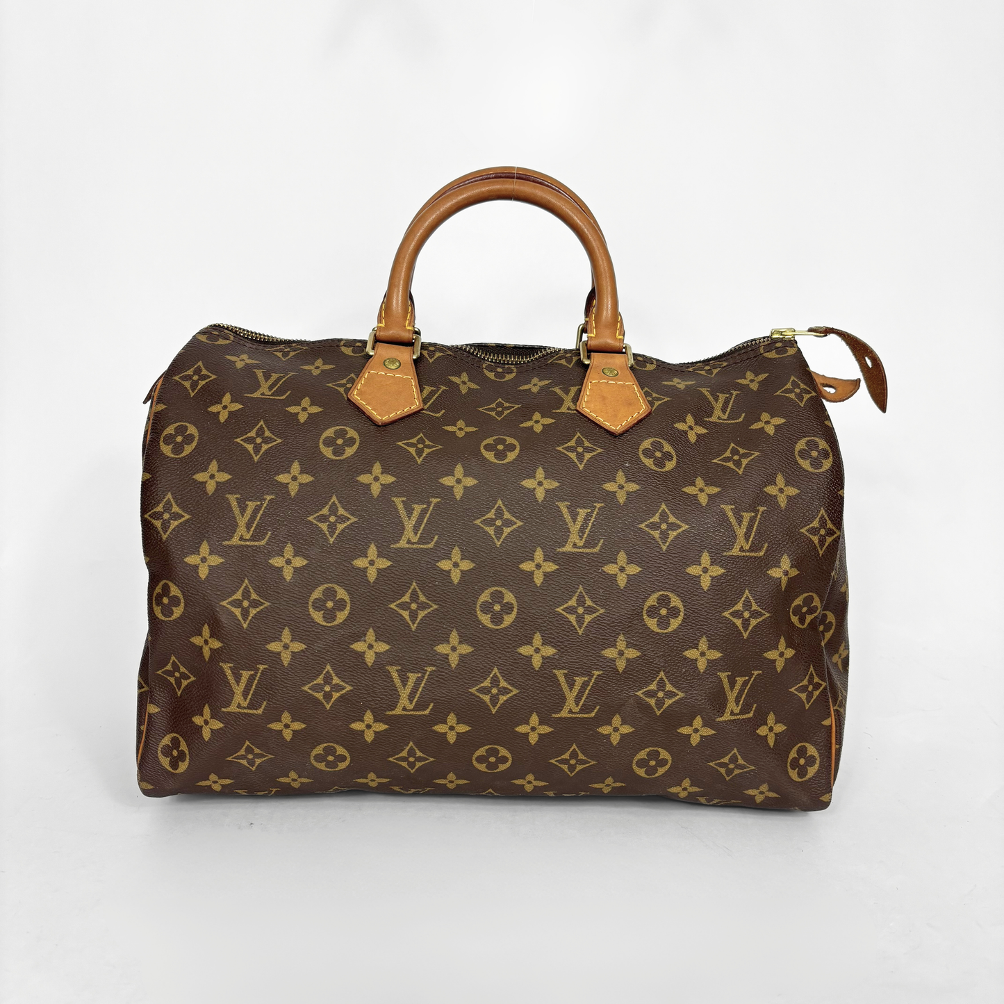 Brown handbag with a monogram pattern on a white background