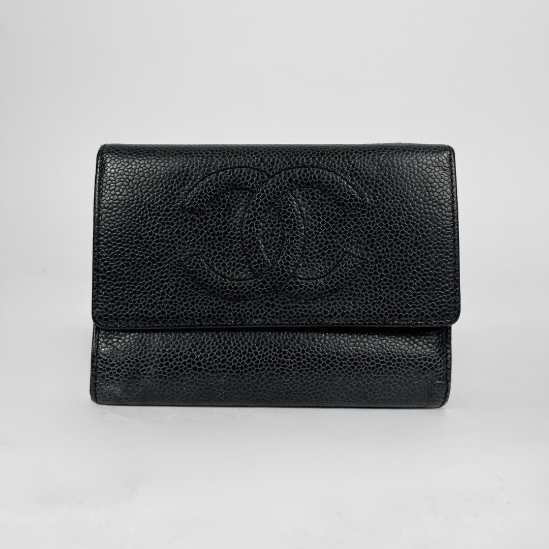 A black pebbled leather wallet with an embossed interlocking CC logo on the front flap, photographed against a light gray background.