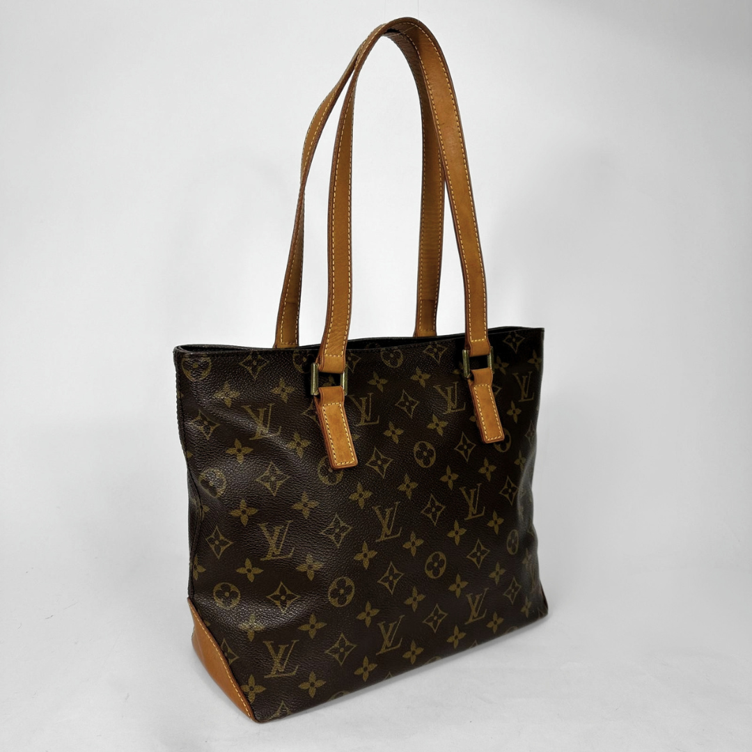 Louis Vuitton monogram canvas tote bag with tan leather shoulder straps and trim, shown on a light gray background.