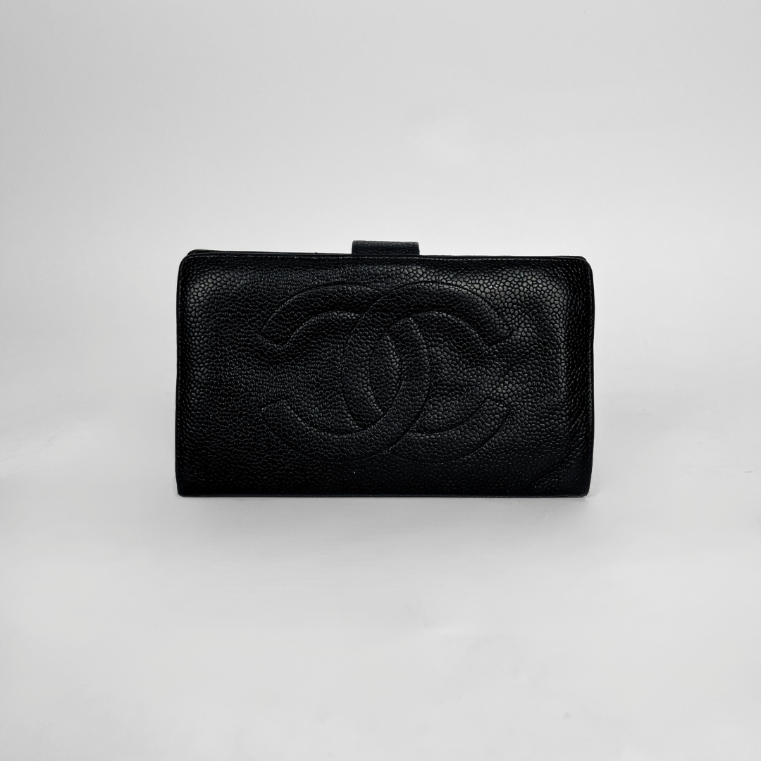 A black textured leather clutch wallet featuring an embossed interlocking CC logo, characteristic of Chanel, set against a plain light gray background.