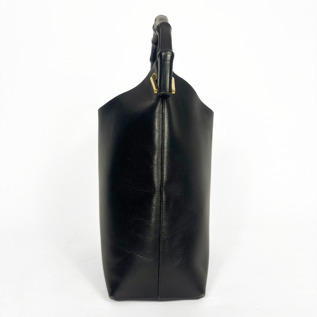 Gucci vintage black leather hobo hag with a dark wood bamboo top handle and gold-tone hardware.