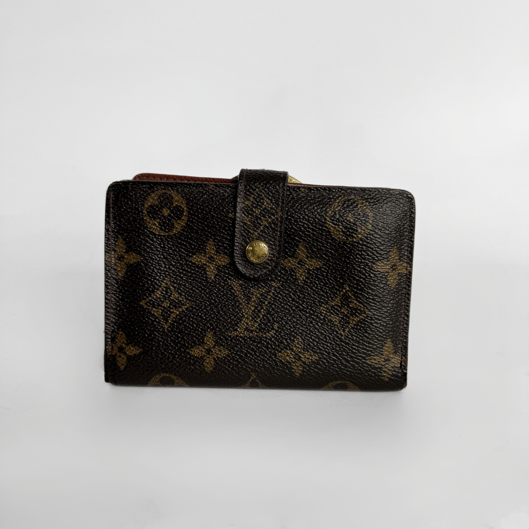 A Louis Vuitton monogram canvas wallet in dark brown with gold-tone hardware, photographed on a light gray background.