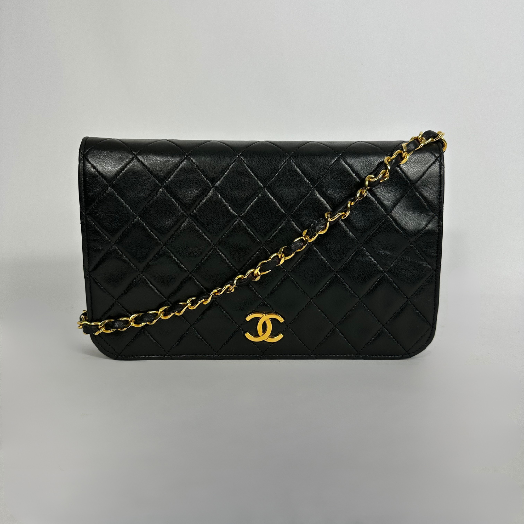 Black Chanel bag on white background