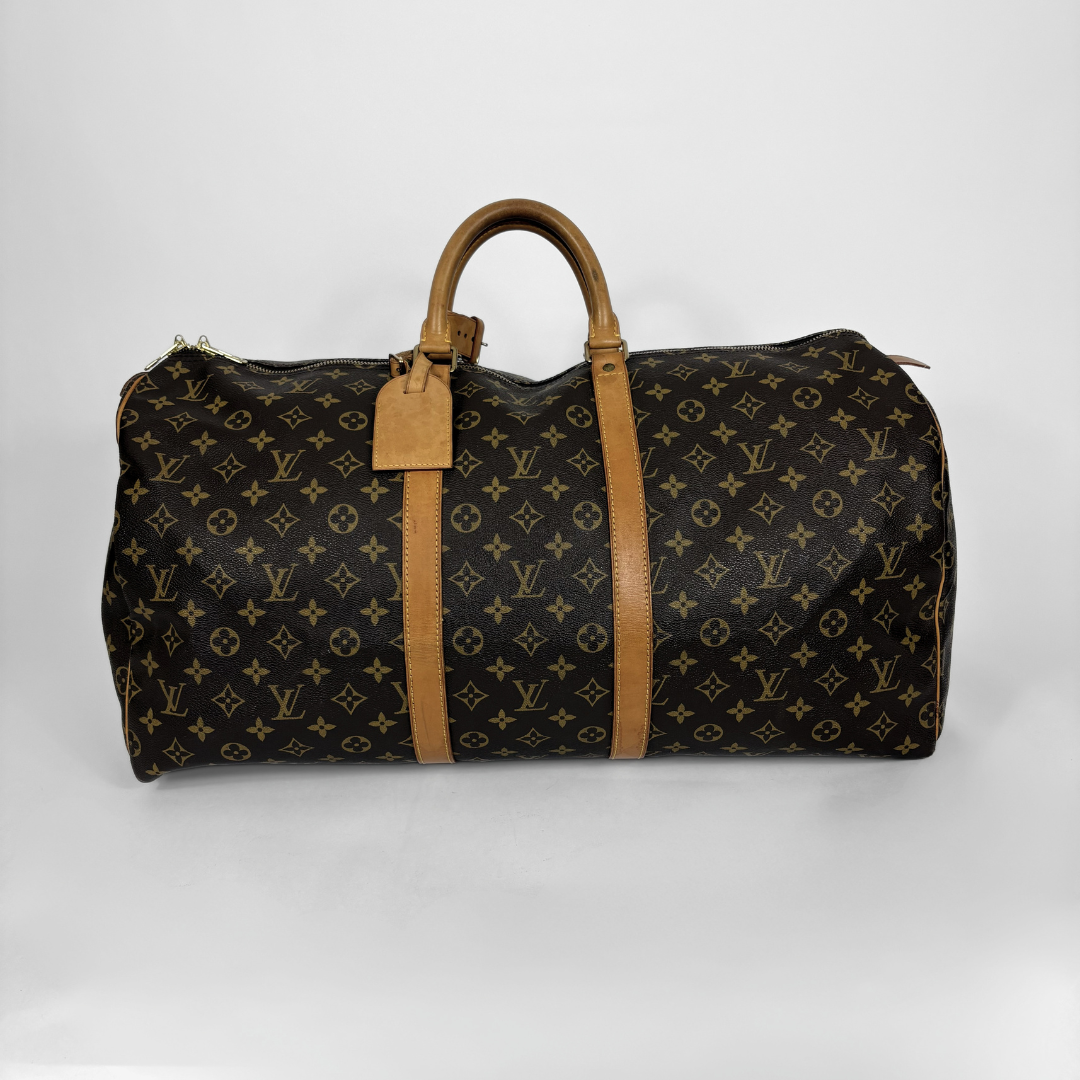 Designer duffel bag with monogram pattern on a white background