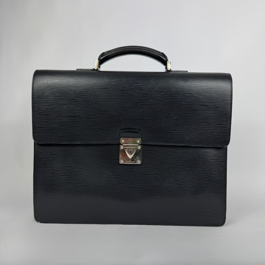 A black textured leather Louis Vuitton briefcase with a top handle and a silver-toned metal clasp on a light gray background.