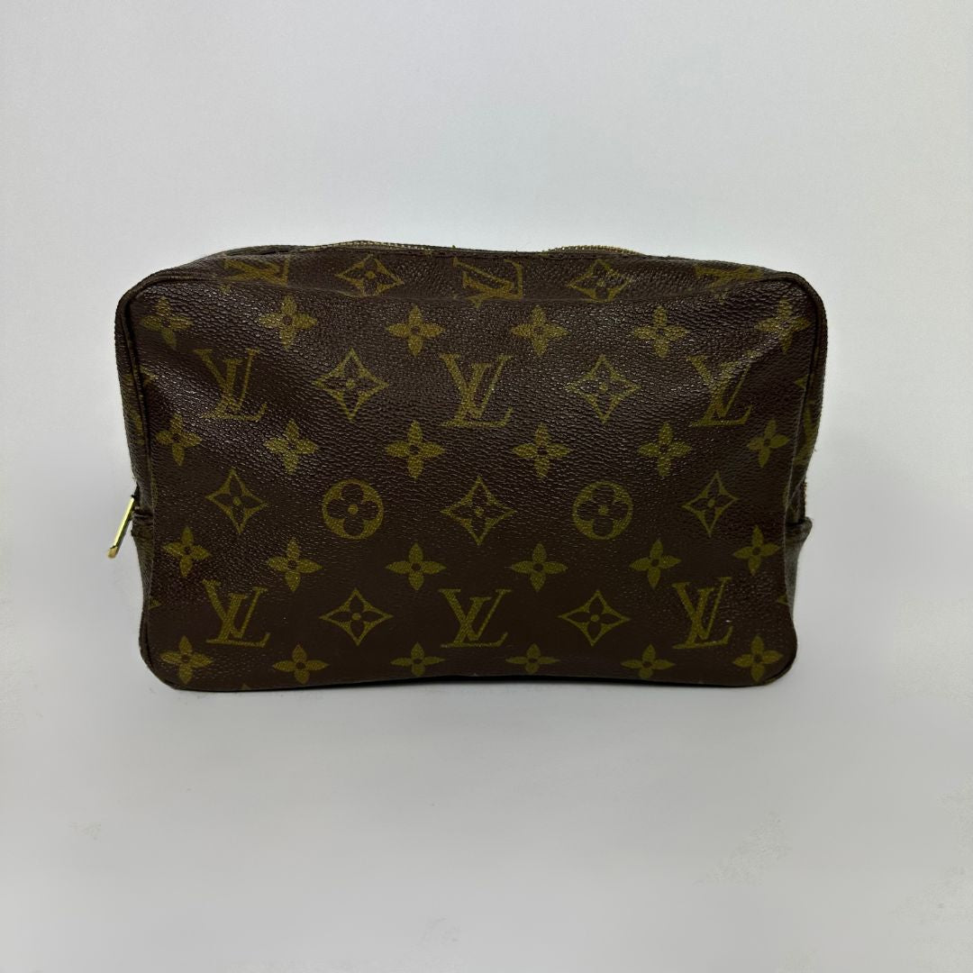 Louis Vuitton toiletry bag in front of white background