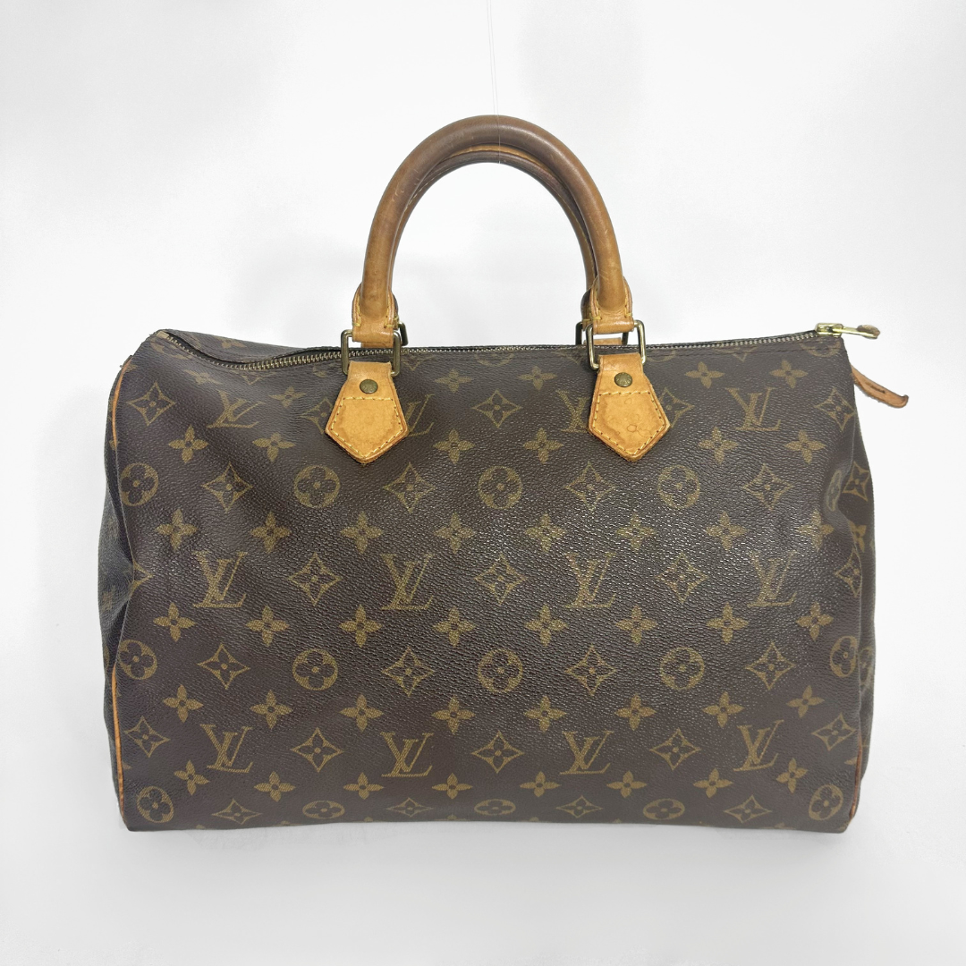 Brown handbag with a monogram pattern on a white background