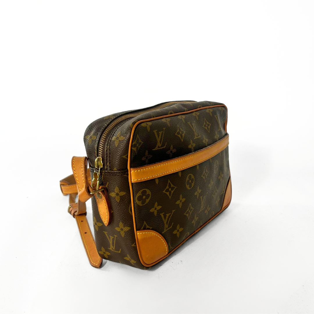 Designer handbag with monogram pattern on a white background