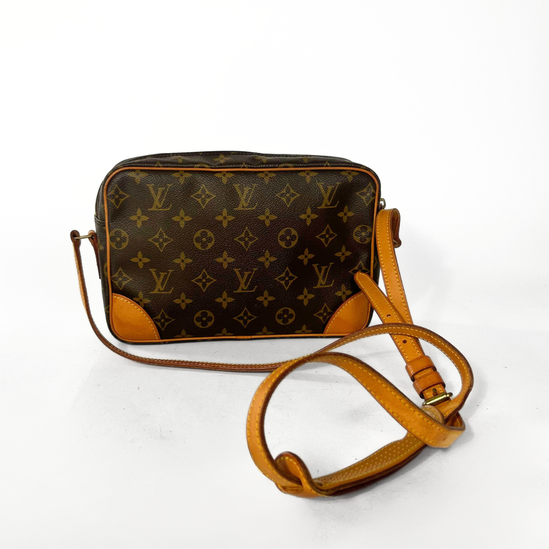 Designer handbag with monogram pattern on a white background