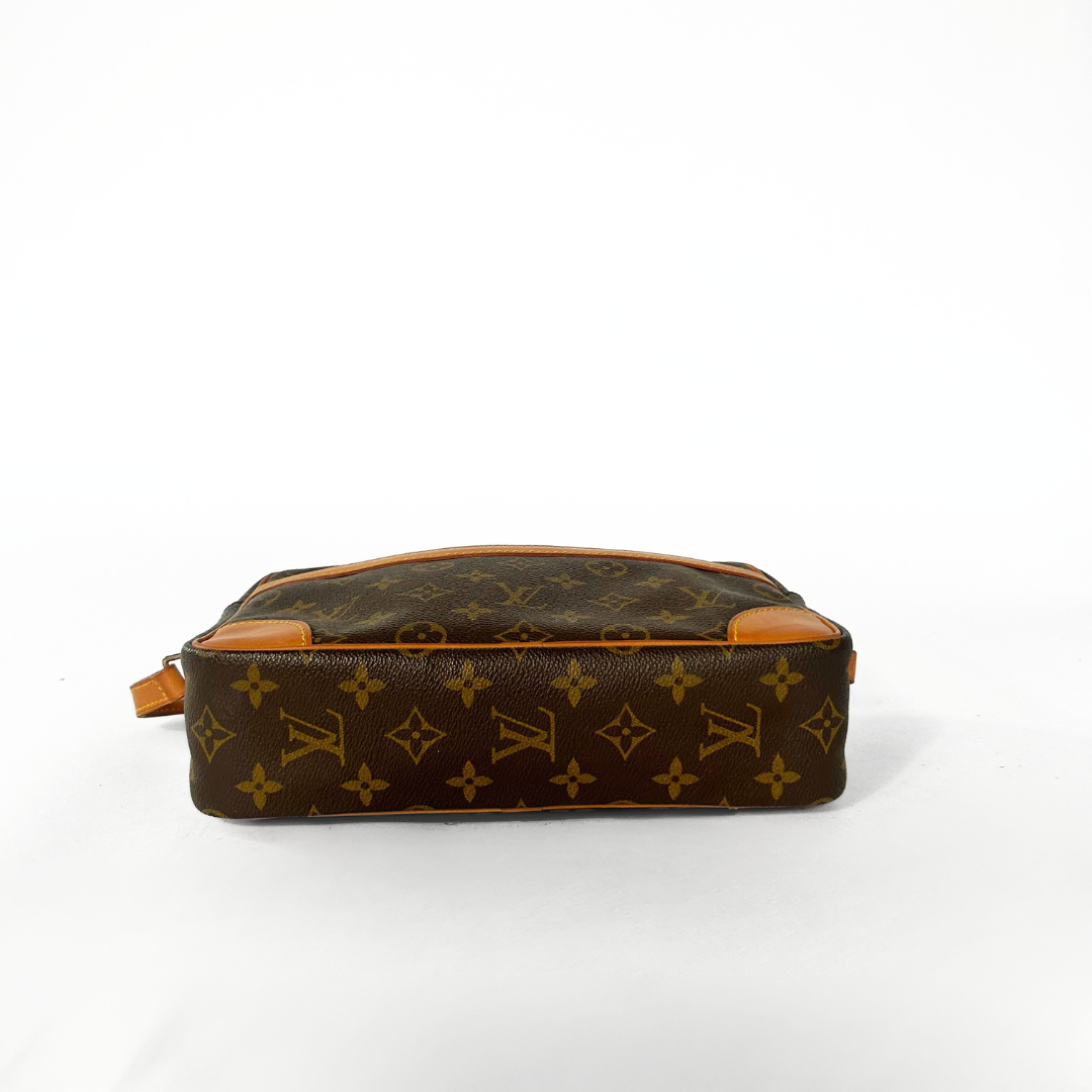 Brown leather pouch with tan interior on a white background