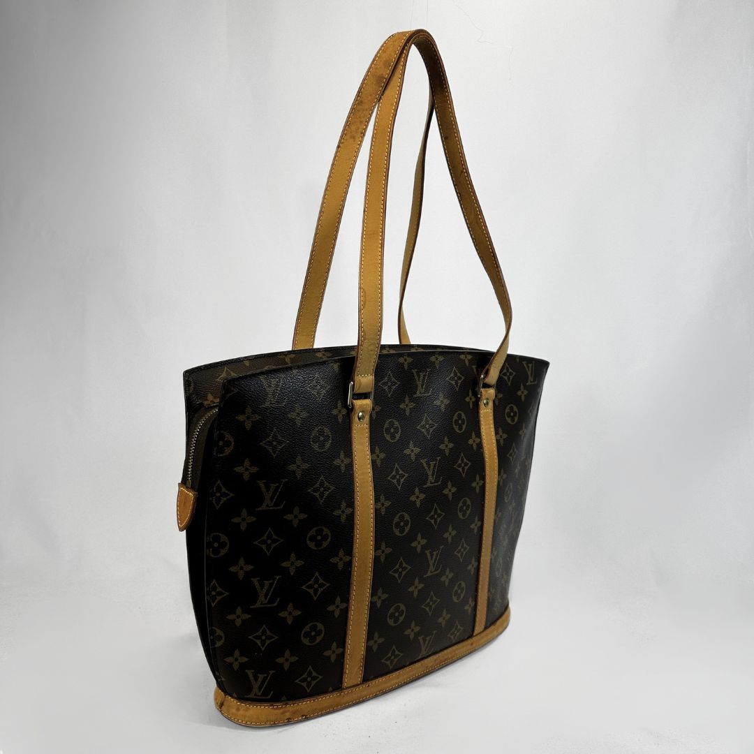 Louis Vuitton monogram canvas Babylon with tan leather shoulder straps and trim, shown against a plain white background.