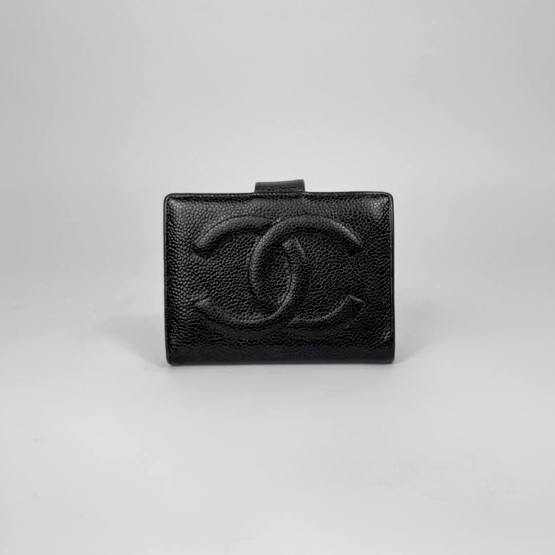 Black caviar leather wallet with Chanel logo on a light gray background