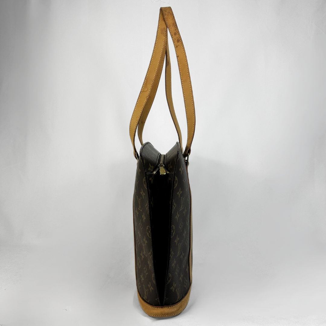 Louis Vuitton monogram canvas Babylon with tan leather shoulder straps and trim, shown against a plain white background.