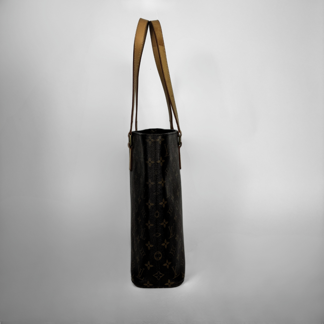 A Louis Vuitton monogram canvas shoulder bag in black, featuring a brown leather shoulder strap and trim, shown against a neutral gray background.