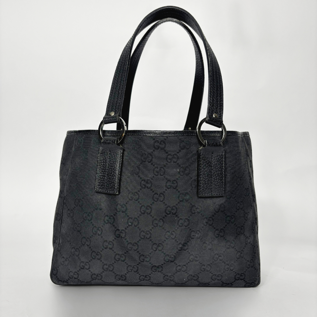Black handbag with a pattern on a white background