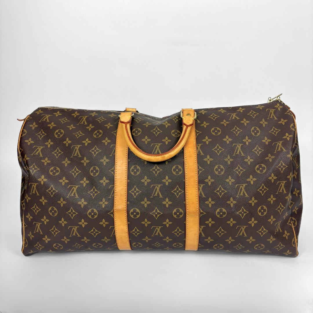 Brown travel bag with yellow handles on a white background