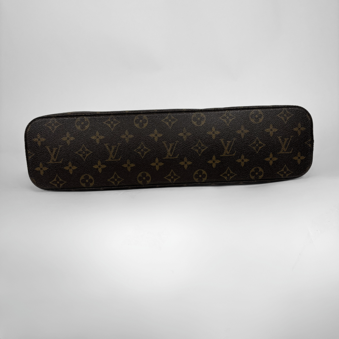 A Louis Vuitton monogram handbag shown open, held by black-gloved hands against a plain light background. The bag has a brown coated canvas exterior with the classic tan and yellow monogram pattern, a tan interior lining, and gold-tone hardware.