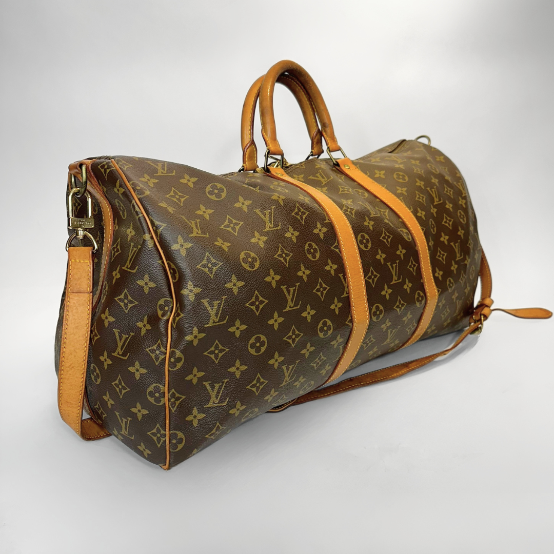 Brown travel bag with tan straps on a light gray background