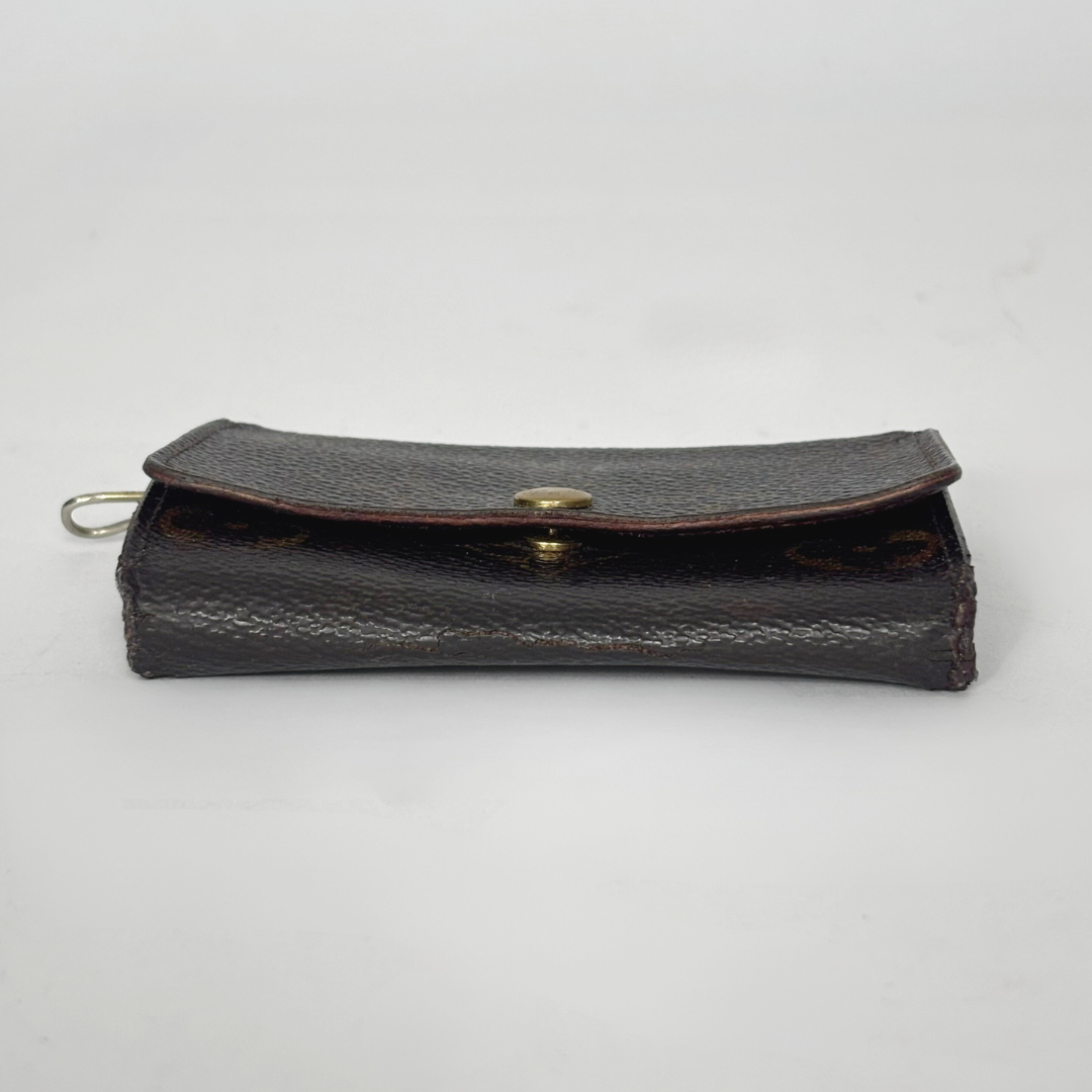 Black leather wallet with gold clasp on a white background