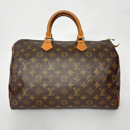 Brown handbag with monogram pattern on a white background