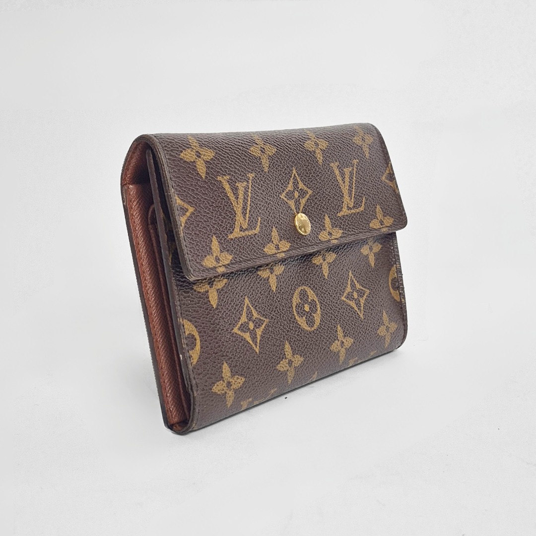 Louis Vuitton wallet with monogram pattern on a white background
