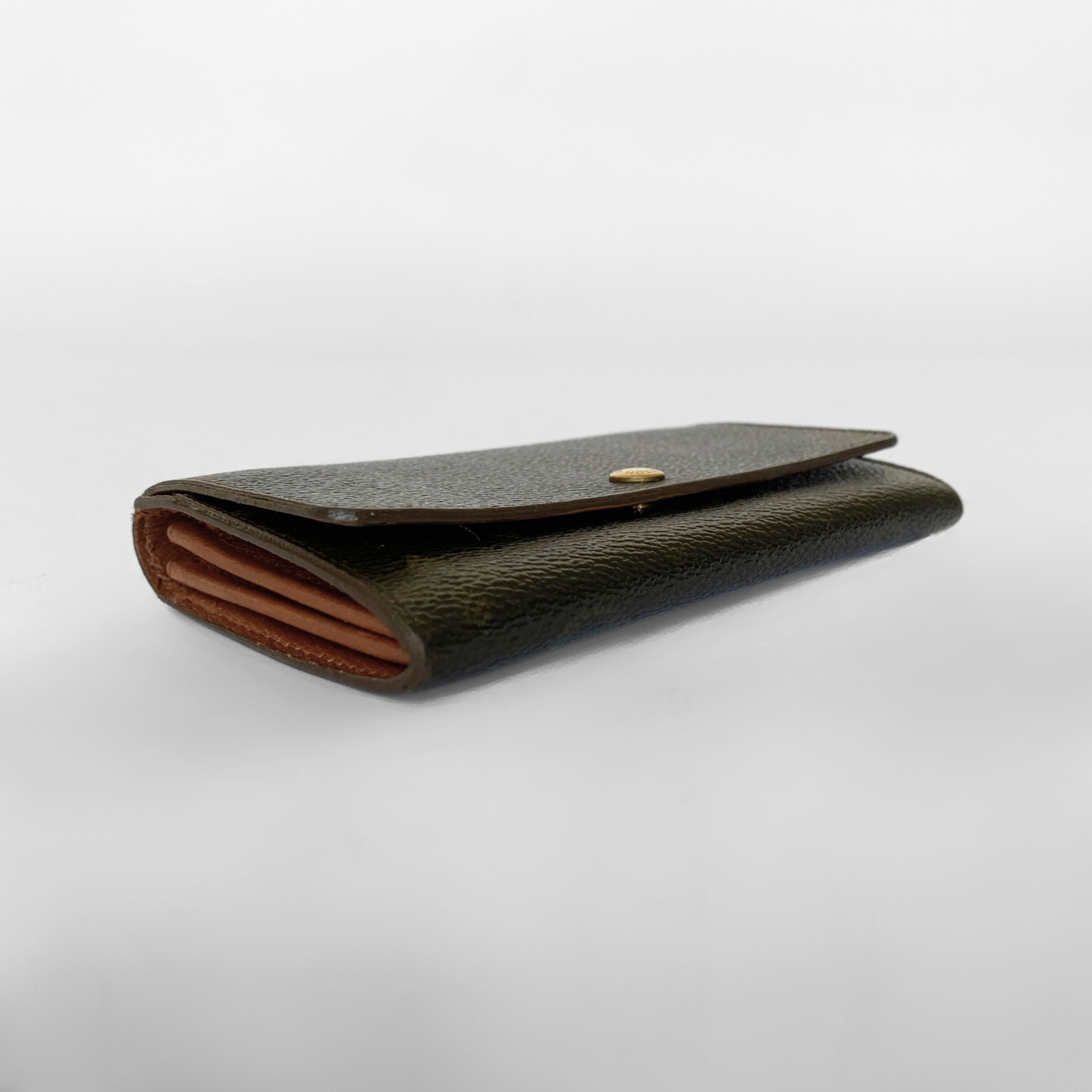 Black leather wallet with a gold button on a white background