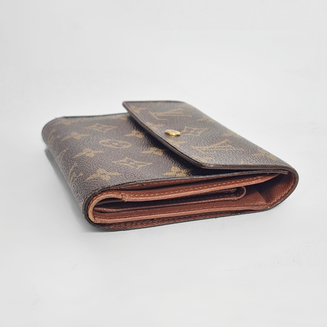 Folded brown wallet with pattern on a light gray background