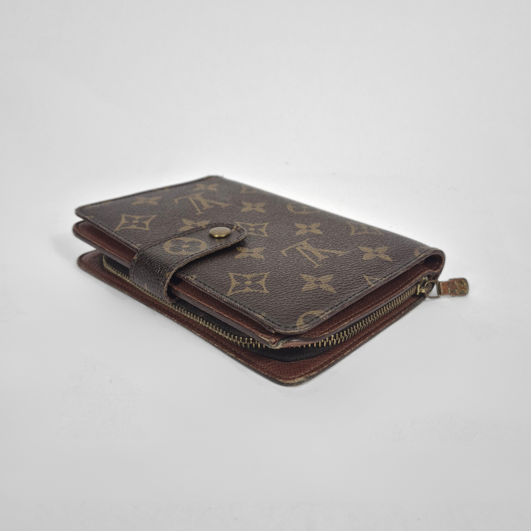 Brown wallet with monogram pattern on a light gray background