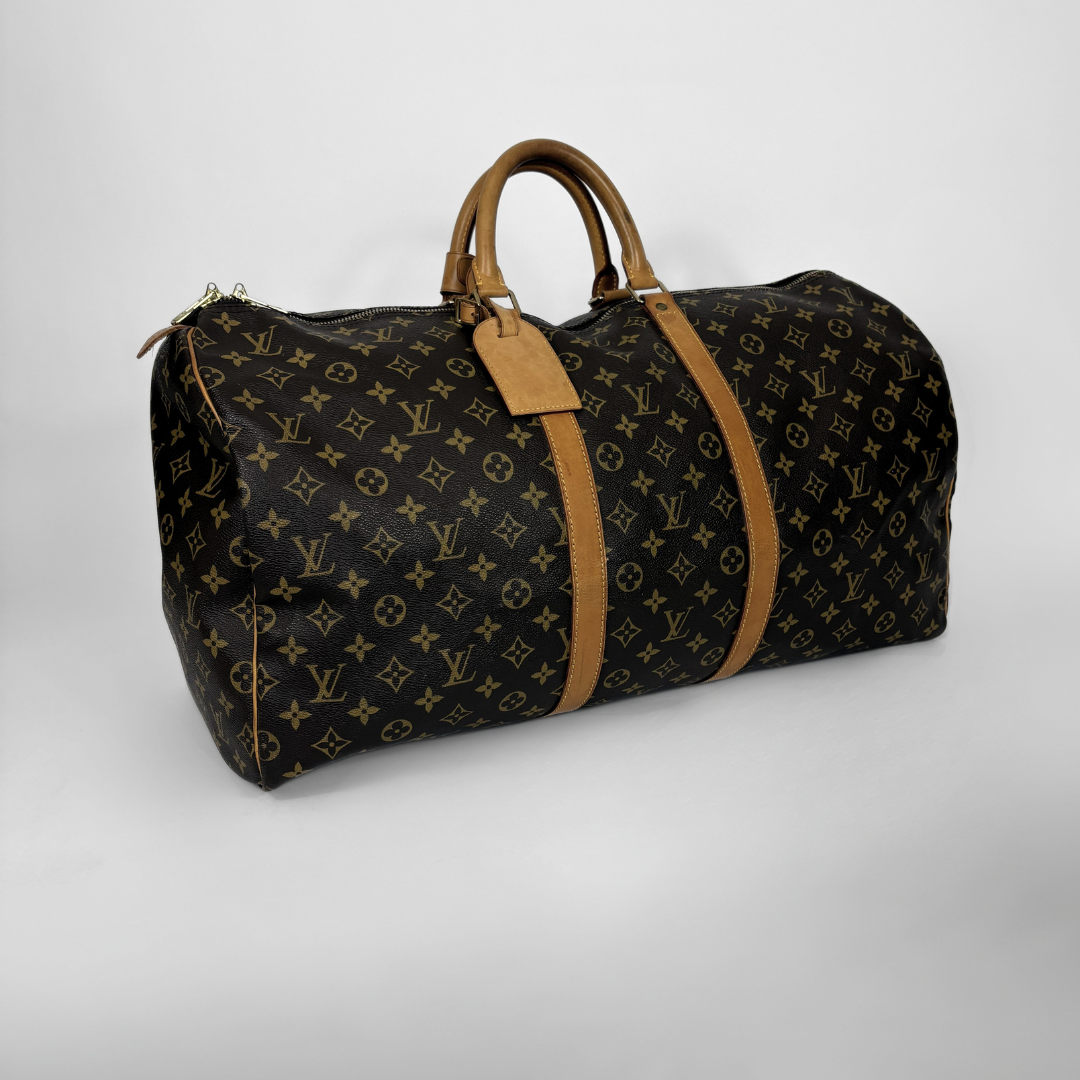 Designer duffel bag with monogram pattern on a light gray background