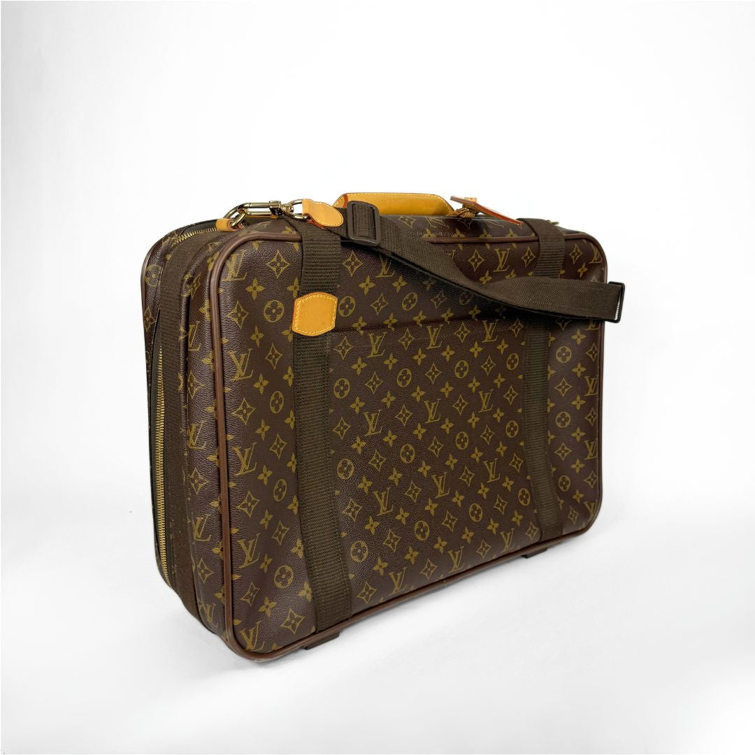 Brown patterned suitcase with a shoulder strap on a white background