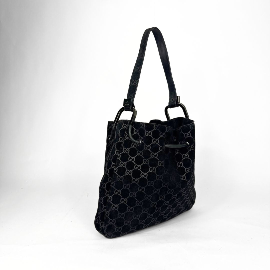 Black patterned handbag on a white background