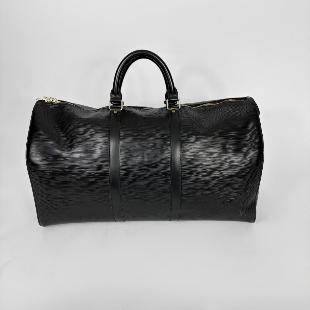 Black leather duffel bag on a light gray background