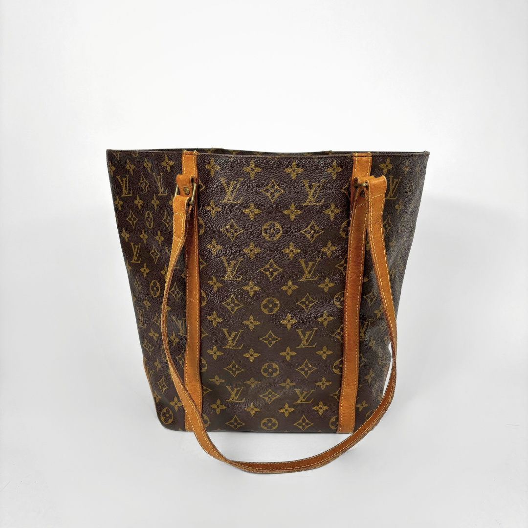 Designer handbag with monogram pattern on a white background